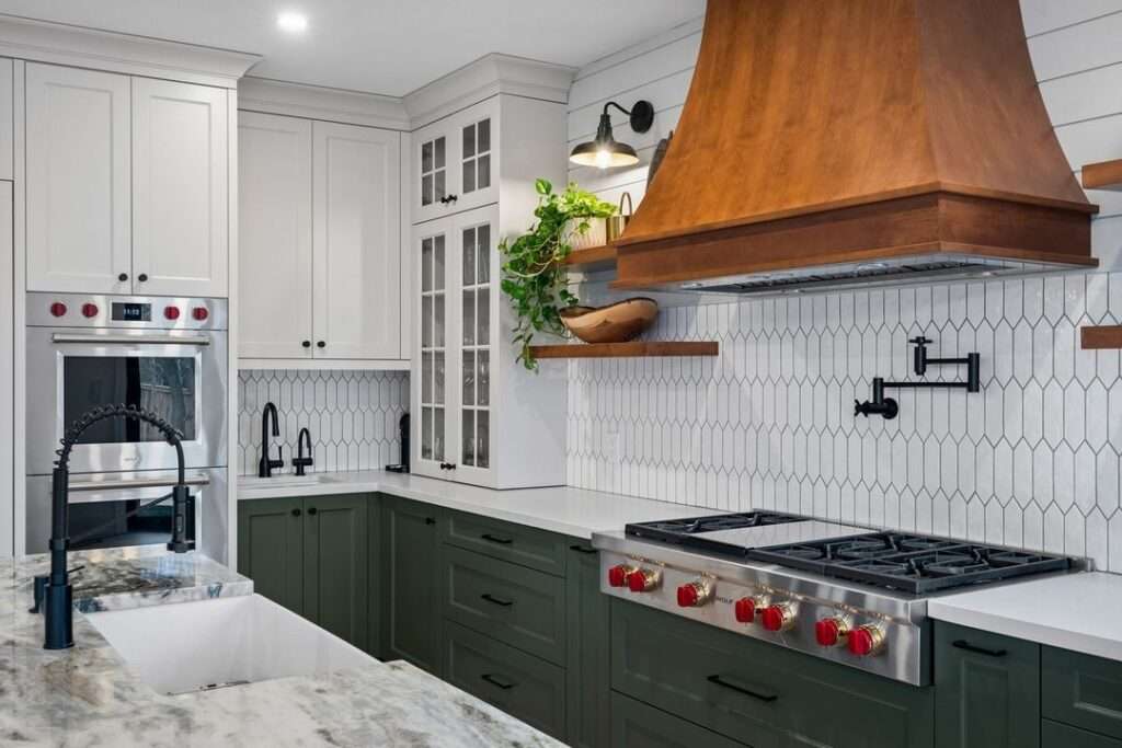 green lower kitchen cabinets with wood range hood